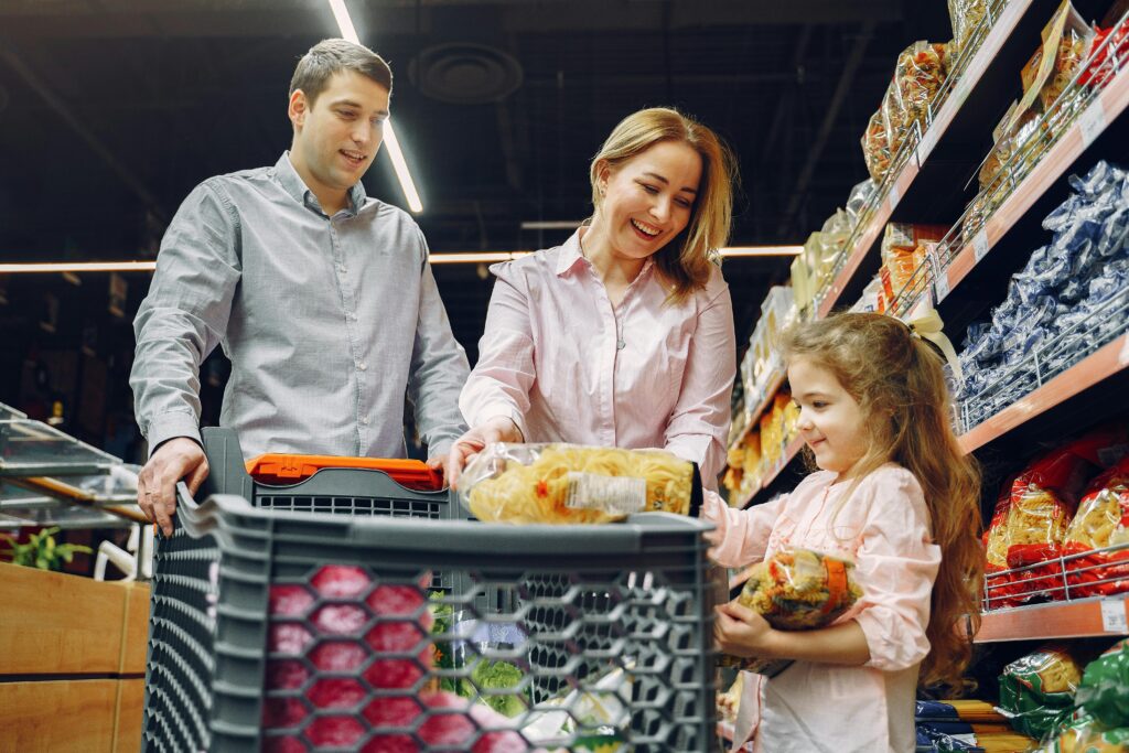 pexels-photo-3985062-3985062 A joyful family of three shopping together in a supermarket, creating a memorable experience.